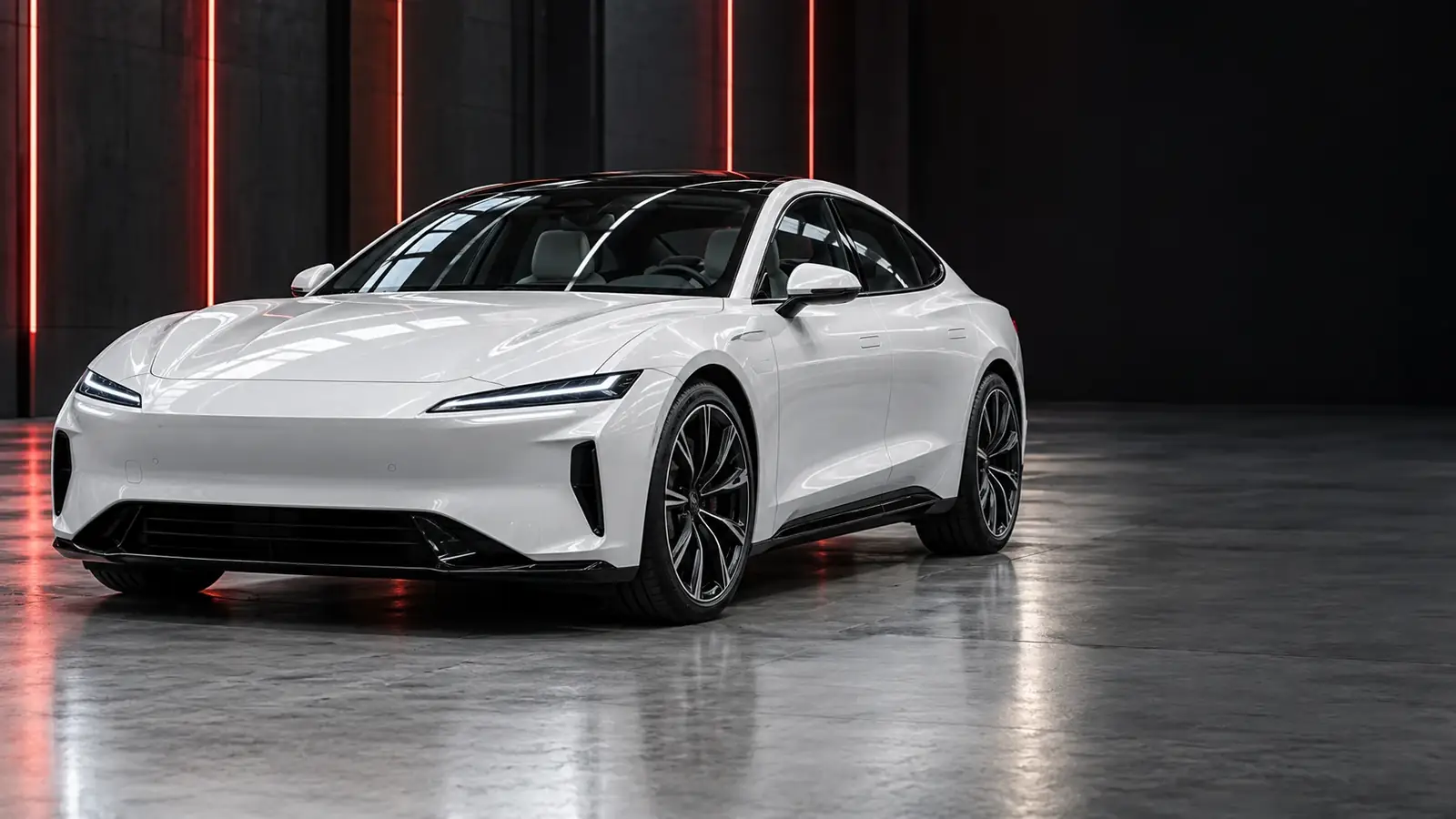 white electric performance vehicle in a dark showroom with red inspection lighting